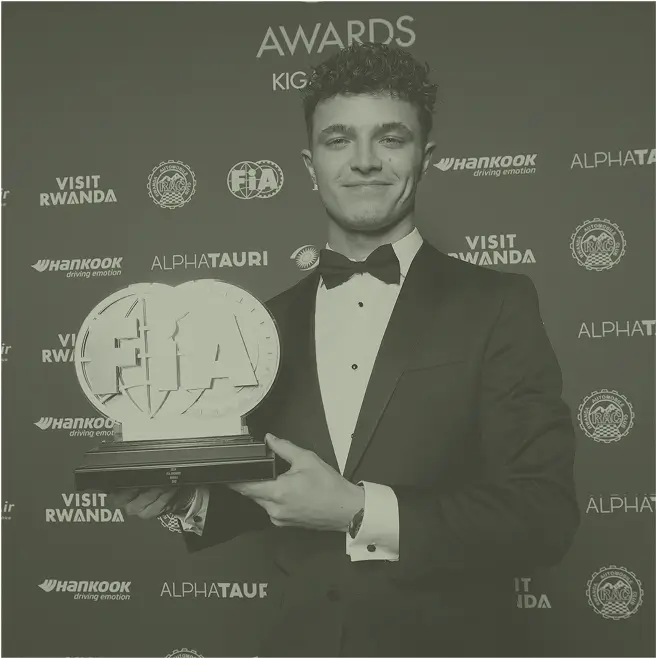 Lando lifting trophy in tux